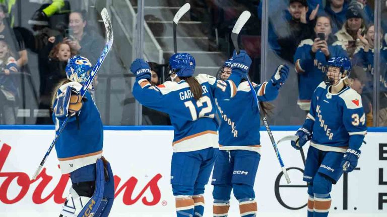 Vancouver Goldeneyes goaltender Emerance Maschmeyer, left, celebrates with her teammates after defeating the New York Sirens during the third period of a PWHL hockey game in Vancouver, on Saturday, December 6, 2025. (Ethan Cairns/CP)