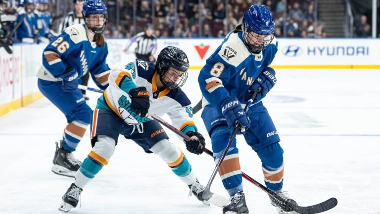 New York Sirens' Kristin O'Neill (43) and Vancouver Goldeneyes' Izzy Daniel (8) vie for the puck as Brooke Mcquigge (26) watches during the third period of a PWHL hockey game in Vancouver, on Saturday, December 6, 2025. THE CANADIAN PRESS/Ethan Cairns