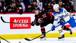 Ottawa Senators' Nikolas Matinpalo (33) and St. Louis Blues' Oskar Sundqvist (70) chase down the puck during first period NHL hockey action in Ottawa, on Saturday, Dec. 6, 2025. (Spencer Colby/CP)