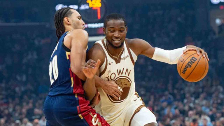 Golden State Warriors' Jonathan Kuminga, right, drives against Cleveland Cavaliers' Jaylon Tyson, during the first half of an NBA basketball game in Cleveland, Saturday, Dec. 6, 2025. (Phil Long/AP)