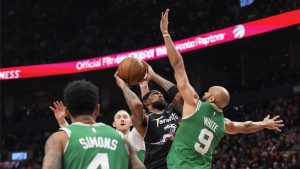 Toronto Raptors forward Brandon Ingram (3) shoots on Boston Celtics guard Derrick White (9) during first half NBA basketball action in Toronto on Sunday December 7, 2025. THE CANADIAN PRESS/Chris Young