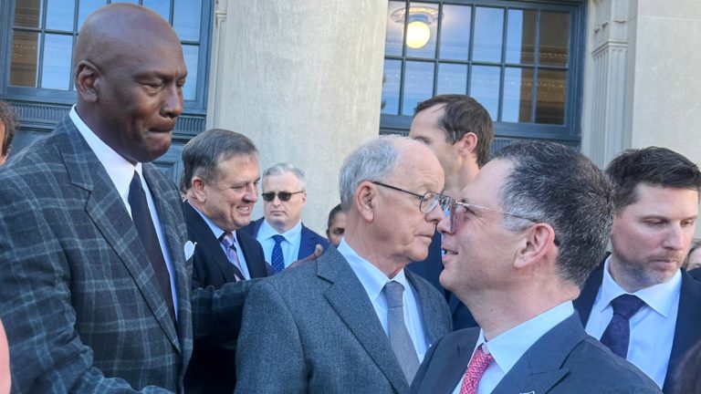 Michael Jordan, left, shakes hands with NASCAR attorney Lawrence Buterman as NASCAR chairman Jim France, centre, looks away, Thursday, Dec. 11, 2025, outside the federal courthouse in Charlotte, N.C. (Jenna Fryer/AP)
