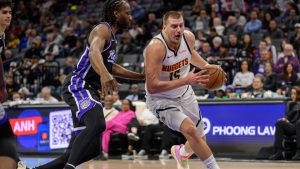 Denver Nuggets centre Nikola Jokic drives past Sacramento Kings forward Precious Achiuwa during the first half of an NBA game in Sacramento, Calif., Thursday, Dec. 11, 2025. (Randall Benton/AP)