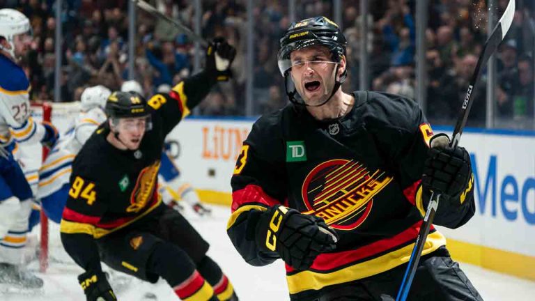 Vancouver Canucks' Max Sasson (right) celebrates along with teammate Linus Karlsson after scoring on the Buffalo Sabres during second period NHL hockey action in Vancouver on Thursday, Dec. 11, 2025. (Rich Lam/AP)