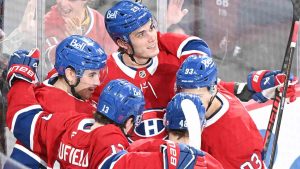 Montreal Canadiens' Nick Suzuki (left) celebrates with teammates Cole Caufield (13), Juraj Slafkovsky (20), Lane Hutson (48) and Ivan Demidov (93) after scoring against the Edmonton Oilers during third period NHL hockey action in Montreal, Sunday, Dec. 14, 2025. (Graham Hughes/CP)