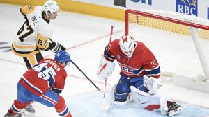 Montreal Canadiens goaltender Jacob Fowler (32) stops Pittsburgh Penguins' Rickard Rakell (67) as Canadiens' Alexandre Carrier (45) defends during third period NHL hockey action in Montreal, Saturday, Dec. 20, 2025. THE CANADIAN PRESS/Graham Hughes