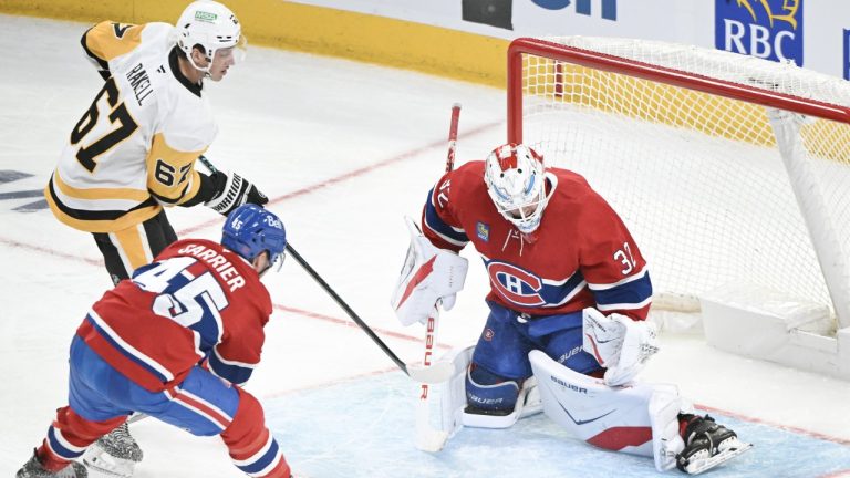 Montreal Canadiens goaltender Jacob Fowler (32) stops Pittsburgh Penguins' Rickard Rakell (67) as Canadiens' Alexandre Carrier (45) defends during third period NHL hockey action in Montreal, Saturday, Dec. 20, 2025. THE CANADIAN PRESS/Graham Hughes