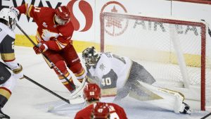 Vegas Golden Knights goalie Akira Schmid is scored on by Calgary Flames' Mikael Backlund during second period NHL hockey action in Calgary on Saturday, Dec. 20, 2025.THE CANADIAN PRESS/Jeff McIntosh