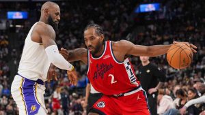 Los Angeles Clippers forward Kawhi Leonard (2) is pressured by Los Angeles Lakers forward Lebron James during the second half of an NBA basketball game Saturday, Dec. 20, 2025, in Inglewood, Calif. (Jae C. Hong/AP)