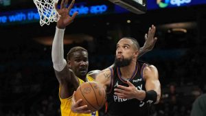 Phoenix Suns forward Dillon Brooks scores on Los Angeles Lakers center Deandre Ayton (5) during the second half of an NBA basketball game, Tuesday, Dec. 23, 2025, in Phoenix. (Rick Scuteri/AP)