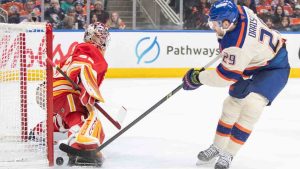 Calgary Flames goalie Dustin Wolf (32) stops Edmonton Oilers' Leon Draisaitl (29) during second period NHL action in Edmonton on Tuesday December 23, 2025. (Amber Bracken/CP)