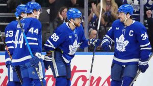 Toronto Maple Leafs right wing William Nylander (88) celebrates his goal with teammates Matias MacCelli (63), Morgan Rielly (44) and Auston Matthews (34) during first period NHL hockey action against the Ottawa Senators, in Toronto, Saturday, Dec. 27, 2025. (Frank Gunn/CP)