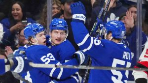 Toronto Maple Leafs centre Bobby McMann (74) celebrates his goal against the New Jersey Devils with teammates Easton Cowan (53) and Nicolas Roy (55) during first period NHL hockey action in Toronto on Tuesday Dec. 30, 2025. (Frank Gunn/CP)