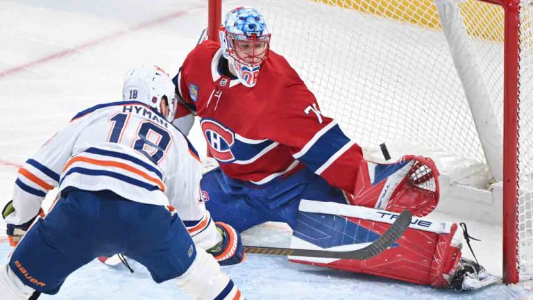 Montreal Canadiens goaltender Jakub Dobes (75) stops Edmonton Oilers' Zach Hyman (18) during first period NHL hockey action in Montreal, Sunday, Dec. 14, 2025. (Graham Hughes/CP)
