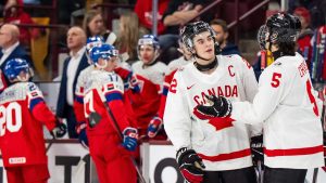 Canada's Porter Martone (22) celebrates his goal with teammate Carson Carels (5) during third period IIHF World Junior Championship hockey action against Czechia in Minneapolis, Friday, Dec. 26, 2025. (Christopher Katsarov/CP)
