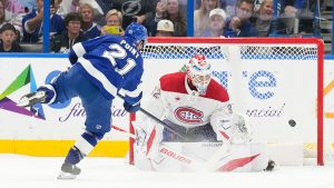 Tampa Bay Lightning centre Brayden Point (21) scores past Montréal Canadiens goaltender Jacob Fowler (32) during a shootout in an NHL hockey game Sunday, Dec. 28, 2025, in Tampa, Fla. (Chris O'Meara/AP)