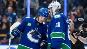 Vancouver Canucks Aatu Raty (54) and goaltender Nikita Tolopilo (60) celebrate after defeating the Minnesota Wild after third period NHL hockey action in Vancouver on Saturday, December 6, 2025. (Ethan Cairns/CP)
