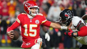 Kansas City Chiefs quarterback Patrick Mahomes (15) scrambles as Houston Texans defensive tackle Mario Edwards Jr. defends during the first half of an NFL football game Sunday, Dec. 7, 2025, in Kansas City, Mo. (Ed Zurga/AP)