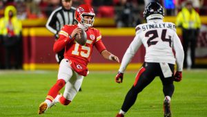 Kansas City Chiefs quarterback Patrick Mahomes (15) scrambles for a first down as Houston Texans cornerback Derek Stingley Jr. (24) defends during the first half of an NFL football game Sunday, Dec. 7, 2025, in Kansas City, Mo. (Charlie Riedel/AP)