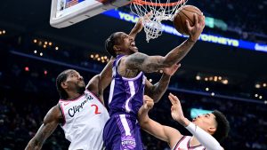 Sacramento Kings guard/forward Demar Derozan, front, is fouled by Los Angeles Clippers forward Kawhi Leonard (2) as teammate Yanic Konan Niederhäuser tries to help on defense in the first half of an NBA basketball game Tuesday, Dec. 30, 2025, in Inglewood, Calif. (AP Photo/Wally Skalij)