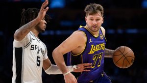Los Angeles Lakers guard Luka Doncic (77) drives to the basket as San Antonio Spurs guard Stephon Castle (5) defends during the second half of an NBA basketball game in Los Angeles, Monday, March 17, 2025. (Kyusung Gong/AP)
