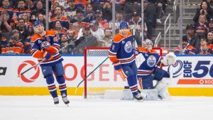 Edmonton Oilers Connor McDavid (97), Evan Bouchard (2), and goalie Stuart Skinner (74) react after losing to the Buffalo Sabres during overtime NHL action in Edmonton, Tuesday, Dec. 9, 2025. The Sabres won 4-3. (Amber Bracken/CP)