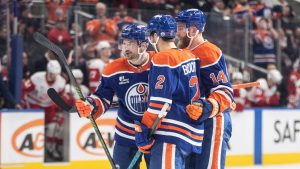 Edmonton Oilers' Zach Hyman (18), Evan Bouchard (2) and Mattias Ekholm (14) celebrate a goal against the Detroit Red Wings during second period NHL action, in Edmonton on Thursday, December 11, 2025. (Jason Franson/CP)