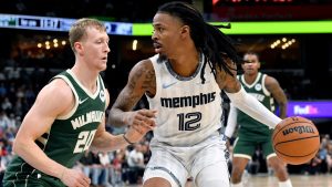 Memphis Grizzlies guard Ja Morant (12) handles the ball against Milwaukee Bucks guard AJ Green (20) in the first half of an NBA basketball game, Friday, Dec. 26, 2025, in Memphis, Tenn. (AP Photo/Brandon Dill)