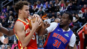 Atlanta Hawks guard Dyson Daniels (5) grabs a rebound against Detroit Pistons guard Javonte Green (31) during the first half of an NBA basketball game Friday, Dec. 12, 2025, in Detroit. (AP Photo/Duane Burleson)