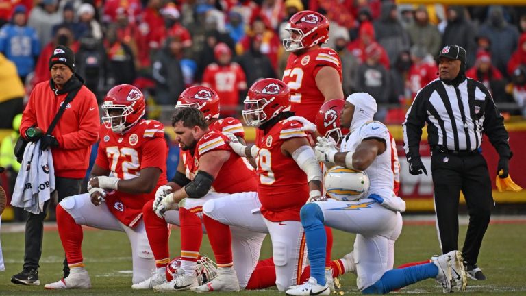 Kansas City Chiefs and Los Angeles Chargers players take a knee after Kansas City Chiefs quarterback Patrick Mahomes (15) is injured during an NFL football game Sunday, Dec. 14, 2025, in Kansas City, Mo. (Peter Aiken/AP)