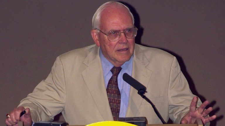 FILE - Southeastern Conference Commissioner Roy Kramer talks with reporters during the opening session of the Southeastern Conference football media days in Birmingham, Ala., on Tuesday, July 25, 2000. (AP/Dave Martin, File)