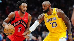 Toronto Raptors' Immanuel Quickley (5) protects the ball from Los Angeles Lakers' LeBron James (23) during first half NBA basketball action in Toronto on Thursday, Dec. 4, 2025. THE CANADIAN PRESS/Frank Gunn