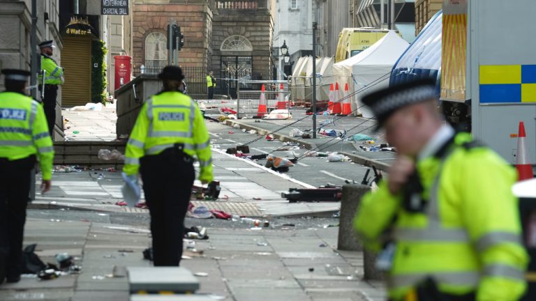 Police officers examine the road after a car collided with pedestrians near the Liver Building during the Premier League winners parade in Liverpool, England, Tuesday, May 27, 2025. (Jon Super/AP)