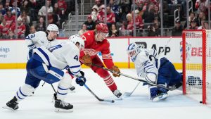 Detroit Red Wings defenceman Simon Edvinsson, third from left, scores the winning goal against Toronto Maple Leafs right wing Easton Cowan, left, defenceman Morgan Rielly, second from left, and goaltender Dennis Hildeby, right, during overtime of an NHL hockey game Sunday, Dec. 28, 2025, in Detroit. (Ryan Sun/AP)
