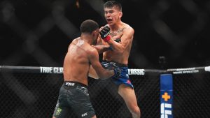 Mario Bautista throws a jumping knee during during a UFC bantamweight matchup. (Frank Franklin II/AP)