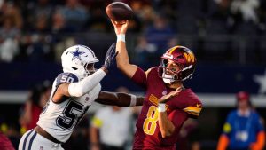 Washington Commanders quarterback Marcus Mariota throws a pass under pressure from Dallas Cowboys linebacker Shemar James during an NFL game Sunday, Oct. 19, 2025, in Arlington, Texas. (AP/Tony Gutierrez)