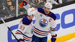 Edmonton Oilers centre Ryan Nugent-Hopkins (93) is congratulated by Connor McDavid after his goal against Boston Bruins goaltender Jeremy Swayman during the first period of an NHL hockey game, Thursday, Dec. 18, 2025, in Boston. (Charles Krupa/AP)