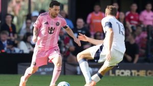 Inter Miami forward Lionel Messi (10) runs with the ball as Vancouver Whitecaps forward Thomas Müller (13) defends during the first half of the MLS Cup final soccer match Saturday, Dec. 6, 2025, in Fort Lauderdale, Fla. (Lynne Sladky/AP)