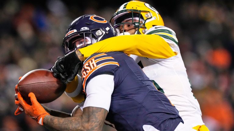 Chicago Bears' DJ Moore catches a touchdown pass with Green Bay Packers' Keisean Nixon defending during overtime of an NFL football game Saturday, Dec. 20, 2025, in Chicago. (Nam Huh/AP)