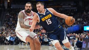 Denver Nuggets centre Nikola Jokić, right, drives past Houston Rockets centre Steven Adams, left, in the first half of an NBA basketball game Monday, Dec. 15, 2025, in Denver. (AP Photo/David Zalubowski)
