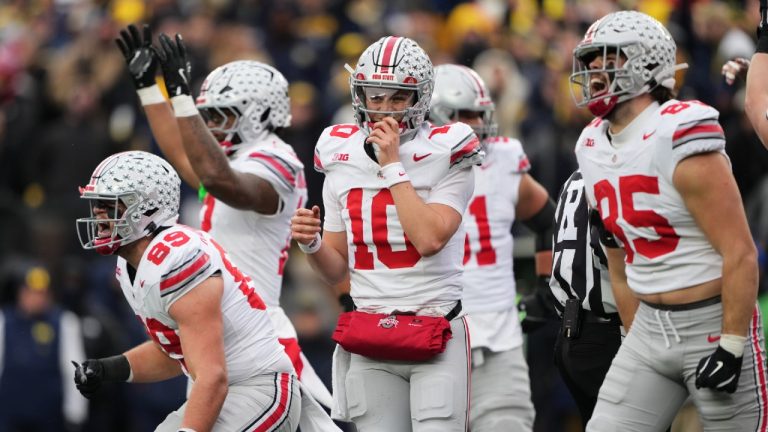 Ohio State quarterback Julian Sayin, center, celebrates near tight ends Will Kacmarek, left, and Bennett Christian after scoring a touchdown during the first half of an NCAA college football game against Michigan, Saturday, Nov. 29, 2025, in Ann Arbor, Mich. (Ryan Sun/AP)