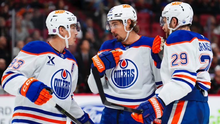 Edmonton Oilers' David Tomasek (86), middle, talks to teammates Nugent-Hopkins (93), and Leon Draisaitl (29) during a break in play during first period NHL hockey action against the Ottawa Senators, in Ottawa on Tuesday, Oct. 21, 2025. (Sean Kilpatrick/CP)