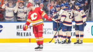 Calgary Flames' Joel Farabee (86) skates off as Edmonton Oilers players celebrate a goal during first period NHL action in Edmonton on Tuesday, December 23, 2025. (Amber Bracken/CP)