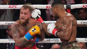 Anthony Joshua, right, punches Jake Paul during their heavyweight boxing match, Friday, Dec. 19, 2025, in Miami, Fla. (Lynne Sladky/AP)