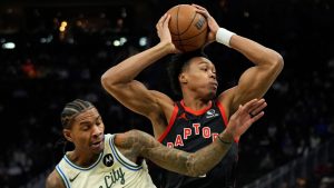 Toronto Raptors' Scottie Barnes, right, drives to the basket against Milwaukee Bucks' Kevin Porter Jr., left, during the first half of an NBA basketball game Thursday, Dec. 18, 2025, in Milwaukee. (Aaron Gash/AP)