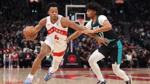 Toronto Raptors forward Scottie Barnes (4) drives up court pass Portland Trail Blazers guard Shaedon Sharpe (17) during first half NBA basketball action in Toronto on Tuesday, Dec. 2, 2025. THE CANADIAN PRESS/Nathan Denette