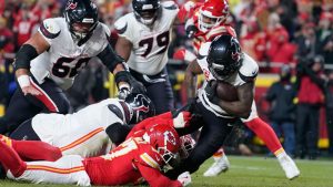 Houston Texans running back Dare Ogunbowale, right, scores past Kansas City Chiefs defensive back Chamarri Conner during the second half of an NFL football game Wednesday, Jan. 7, 2026, in Kansas City, Mo. (Ed Zurga/ AP)