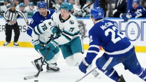 San Jose Sharks forward Macklin Celebrini (71) breaks past Toronto Maple Leafs defenceman Jake McCabe (22) during first period NHL hockey action in Toronto, Monday, March 3, 2025. (Nathan Denette/CP)
