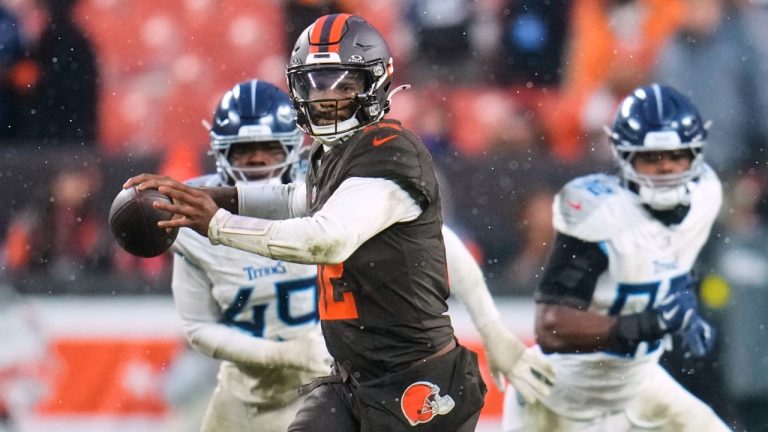 Cleveland Browns quarterback Shedeur Sanders (12) throws a pass under pressure from Tennessee Titans defenders in the second half of an NFL football game in Cleveland, Sunday, Dec. 7, 2025. (AP Photo/Sue Ogrocki)