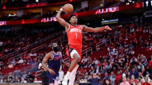 Houston Rockets guard Amen Thompson, right, goes up to dunk in front of LA Clippers guard James Harden, left, during the first half of an NBA basketball game Thursday, Dec. 11, 2025, in Houston. (Michael Wyke/AP)